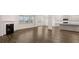 Living room featuring a fireplace, ample natural light from large windows, and an adjacent modern kitchen at 1099 Blue Juniper Cir, Loganville, GA 30052