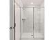 A full glass shower with marble walls and chrome trim and showerhead are some highlights of this bathroom at 1099 Blue Juniper Cir, Loganville, GA 30052