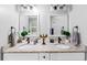 Bathroom featuring dual vanity sinks with granite countertops, framed mirrors, and modern matte black faucets at 1115 Martin Luther King Jr Sw Dr, Atlanta, GA 30314