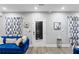 Cozy living room with a blue velvet sofa, stylish curtains, and neutral walls creating a comfortable atmosphere at 1115 Martin Luther King Jr Sw Dr, Atlanta, GA 30314