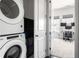 Efficient laundry room with stackable washer and dryer, located near a convenient workspace and bedroom at 3905 Danube Ln # 215, Atlanta, GA 30339