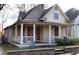 Charming home featuring a front porch with columns and a brick foundation at 698 Ira St, Atlanta, GA 30310
