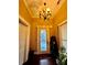 View of the foyer and front door with decorative glass and a chandelier at 698 Ira St, Atlanta, GA 30310