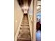 Carpeted staircase with wooden railing and white trim leading to the second floor at 698 Ira St, Atlanta, GA 30310