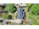 Aerial view of brick home featuring mature landscaping, and a cozy deck at 865 Mount Katahdin Trl, Johns Creek, GA 30022