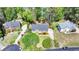 Aerial shot showcases this brick home's curb appeal with professional landscaping and mature trees at 865 Mount Katahdin Trl, Johns Creek, GA 30022