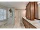 Bathroom featuring a double sink vanity, marble shower, and modern fixtures at 865 Mount Katahdin Trl, Johns Creek, GA 30022