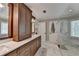 Spacious bathroom features a dual sink vanity with a marble countertop and a glass enclosed shower at 865 Mount Katahdin Trl, Johns Creek, GA 30022