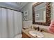 Bathroom with wainscoting, a patterned mirror, granite vanity, and a walk-in shower at 865 Mount Katahdin Trl, Johns Creek, GA 30022