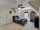 Attic bedroom featuring a ceiling fan, a blue bed set, and a window with natural light at 865 Mount Katahdin Trl, Johns Creek, GA 30022