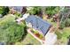 Brick home boasts professional landscaping, a driveway, and mature trees at 865 Mount Katahdin Trl, Johns Creek, GA 30022