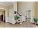 Elegant foyer featuring hardwood floors, white trim, a staircase, and plants at 865 Mount Katahdin Trl, Johns Creek, GA 30022