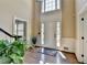 Bright foyer with hardwood floors, high ceilings, a decorative rug and an elegant front door at 865 Mount Katahdin Trl, Johns Creek, GA 30022
