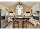 Kitchen with white cabinets, granite countertops, stainless steel appliances, and a large arched window at 865 Mount Katahdin Trl, Johns Creek, GA 30022
