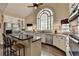 Kitchen featuring an island, white cabinets, granite countertops, and stainless steel appliances at 865 Mount Katahdin Trl, Johns Creek, GA 30022