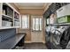Well-organized laundry room with a washer, dryer, storage, and counter space at 865 Mount Katahdin Trl, Johns Creek, GA 30022