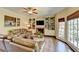 Living room with a fireplace, built-in shelving, hardwood floors, and large windows at 865 Mount Katahdin Trl, Johns Creek, GA 30022