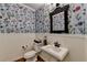 Charming powder room with floral wallpaper and white wainscoting at 865 Mount Katahdin Trl, Johns Creek, GA 30022
