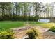 Backyard area featuring an outdoor seating area on a stone patio and a storage shed in the wooded yard at 2876 Wendwood Dr, Marietta, GA 30062