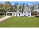 Charming two-story home with a spacious front yard, covered car port, and eye-catching arched facade at 2876 Wendwood Dr, Marietta, GA 30062