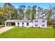 Charming two-story home with a spacious front yard, covered car port, and eye-catching arched facade at 2876 Wendwood Dr, Marietta, GA 30062
