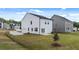A spacious backyard, showcasing ample green space, a freshly poured concrete patio, and a two car garage at 354 Friendship Oak Way, Hampton, GA 30228