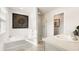 Bathroom featuring a soaking tub, a shower with a glass door, and stylish fixtures at 354 Friendship Oak Way, Hampton, GA 30228