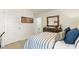 Cozy bedroom featuring light blue bedding, neutral carpet, a modern dresser and stadium art at 354 Friendship Oak Way, Hampton, GA 30228