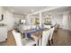 Open-concept dining room and kitchen features stainless steel appliances, light cabinetry, and wood floors at 354 Friendship Oak Way, Hampton, GA 30228