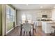 Dining room with hardwood floors, a dining table set, and large windows for ample natural light at 354 Friendship Oak Way, Hampton, GA 30228