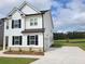 A charming two-story home with black shutters, a side-entry garage, and a well-manicured lawn at 354 Friendship Oak Way, Hampton, GA 30228