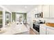 Bright kitchen showcasing granite countertops, stainless steel appliances, and an adjacent dining area at 354 Friendship Oak Way, Hampton, GA 30228