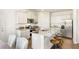 Stylish kitchen boasts granite countertops, stainless appliances, and a spacious island with bar stools at 354 Friendship Oak Way, Hampton, GA 30228