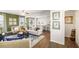 Inviting living area with hardwood floors, comfortable seating, and an open layout to the kitchen at 354 Friendship Oak Way, Hampton, GA 30228