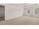 A spacious main bedroom features plush carpeting, a tray ceiling, and great natural light at 354 Friendship Oak Way, Hampton, GA 30228