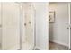 Clean shower with glass doors and built-in shelves for storage of bath and body products at 354 Friendship Oak Way, Hampton, GA 30228
