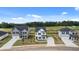 New construction homes line a street with expansive lawns, a perfect location in a quiet neighborhood at 354 Friendship Oak Way, Hampton, GA 30228
