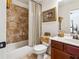 Bathroom with tiled shower, a vanity with a sink, and decorative gold-tone accents at 3613 Lake Estates Way, Atlanta, GA 30349