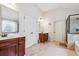 This bright bathroom offers a large soaking tub, glass enclosed shower, and stylish tile, promoting relaxation at 3613 Lake Estates Way, Atlanta, GA 30349
