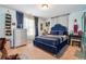 Comfortable bedroom featuring a striking blue bed and matching decor with natural light at 3613 Lake Estates Way, Atlanta, GA 30349