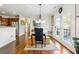 Dining area with hardwood floors, modern lighting, and access to the outdoor deck and kitchen at 3613 Lake Estates Way, Atlanta, GA 30349