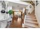 Open foyer with hardwood floors, staircase, and view into the living room with lots of natural light at 3613 Lake Estates Way, Atlanta, GA 30349