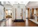 Inviting foyer with hardwood floors, a statement rug, and views into the dining and living areas at 3613 Lake Estates Way, Atlanta, GA 30349
