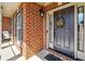 Charming front entrance with a brick facade, decorative wreath, and welcoming curb appeal at 3613 Lake Estates Way, Atlanta, GA 30349