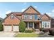 Charming two-story brick home with well-manicured landscaping, mature trees, and a two-car garage at 3613 Lake Estates Way, Atlanta, GA 30349