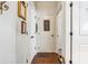 Hallway with white walls and doors, featuring dark wood floors and stylish decor at 3613 Lake Estates Way, Atlanta, GA 30349