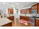 The spacious kitchen has granite counters, stainless steel appliances, and warm wood cabinets, creating an inviting space at 3613 Lake Estates Way, Atlanta, GA 30349