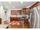 Kitchen featuring stainless steel appliances, wood cabinets, granite countertops, and hardwood floors at 3613 Lake Estates Way, Atlanta, GA 30349
