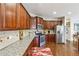 The spacious kitchen has granite counters, stainless steel appliances, and warm wood cabinets, creating an inviting space at 3613 Lake Estates Way, Atlanta, GA 30349