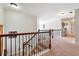 Upstairs landing features a stylish railing, neutral carpeting, and abundant natural light at 3613 Lake Estates Way, Atlanta, GA 30349
